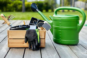 Image showing box with garden tools and watering can in summer