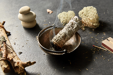 Image showing smoking white sage in cup and other magic staff