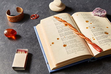 Image showing magic book, wax candle, matches and gem stones