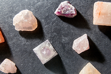 Image showing quartz crystal pyramid and gem stones on slate