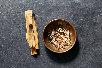 Image showing palo santo sticks and cup with burnt matches