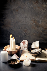 Image showing magic book, sage, burning candles and ritual staff