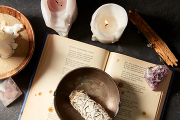 Image showing magic book, sage, burning candles and ritual staff