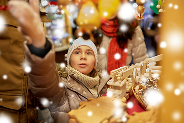 Image showing happy family buying souvenirs at christmas market