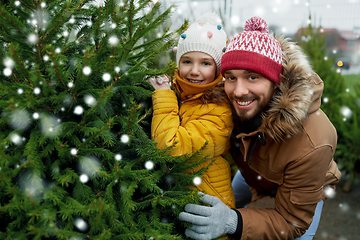 Image showing happy family choosing christmas tree at market