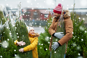 Image showing happy family buying christmas tree at market