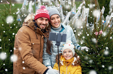 Image showing family taking selfie with christmas tree at market