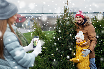 Image showing family taking picture of christmas tree at market