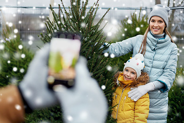 Image showing family taking picture of christmas tree at market