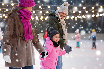 Image showing happy family at outdoor skating rink in winter