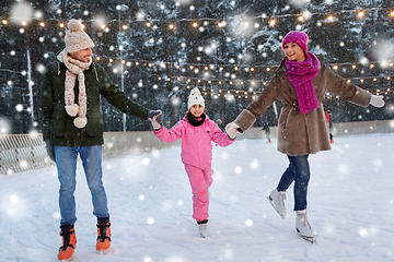 Image showing happy family at outdoor skating rink in winter