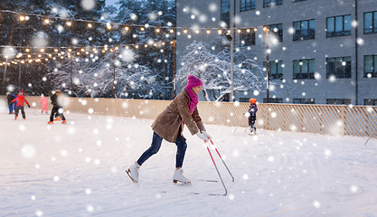 Image showing happy woman at outdoor skating rink in winter