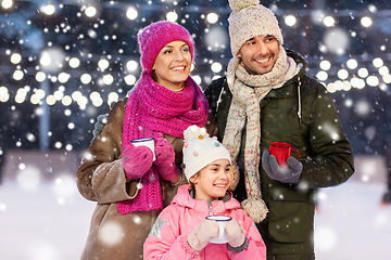 Image showing happy family drinking hot tea on skating rink