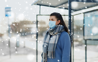 Image showing young woman wearing medical mask at bus stop