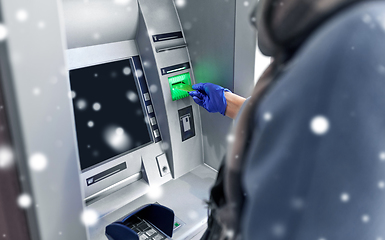 Image showing woman in medical glove with credit card at atm