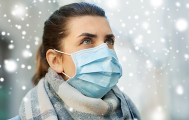 Image showing young woman wearing protective medical mask