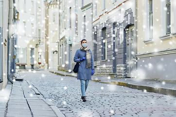 Image showing young woman wearing protective medical mask