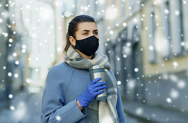 Image showing woman in reusable mask with tumbler in city