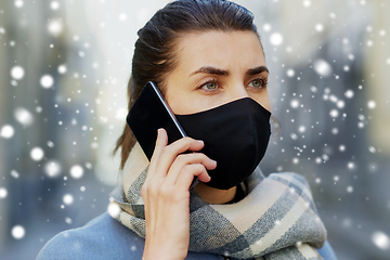 Image showing woman in protective reusable mask calling on phone