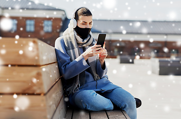 Image showing woman in face mask with smartphone in city