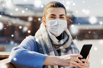 Image showing woman in face mask with smartphone in city