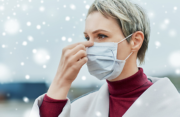 Image showing young woman wearing protective medical mask