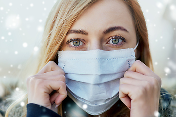 Image showing young woman wearing protective medical mask