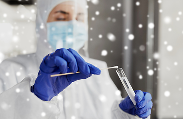 Image showing scientist holding beaker with coronavirus test