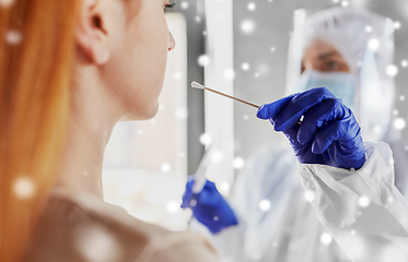 Image showing doctor in protective wear making coronavirus test