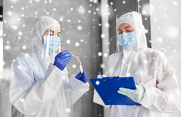 Image showing doctors in medical mask and shield with clipboard