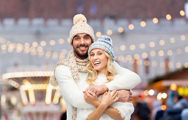 Image showing couple in winter hugging over christmas market