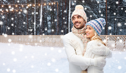 Image showing couple hugging over ice skating rink in winter