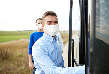 Image showing group of passengers in masks boarding travel bus