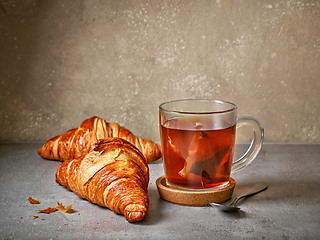 Image showing freshly baked croissants and tea cup