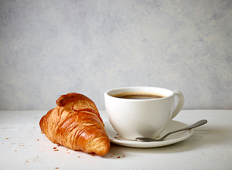 Image showing freshly baked croissant and cup of coffee