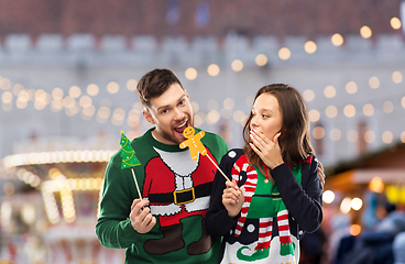 Image showing couple with christmas party props in ugly sweaters