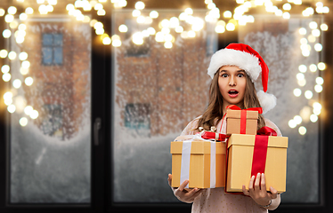 Image showing teenage girl in santa hat with christmas gift