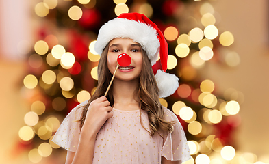 Image showing happy teenage girl in santa hat on christmas