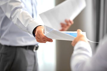 Image showing close up of business team with papers at office