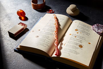 Image showing magic book, wax candle, matches and gem stones