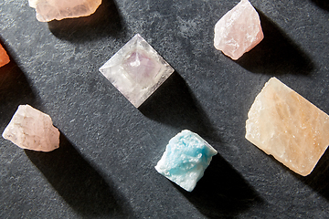 Image showing quartz crystal pyramid and gem stones on slate