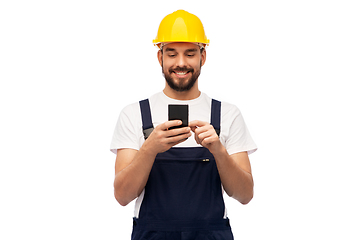 Image showing happy male worker or builder with smartphone