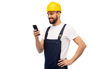 Image showing happy male worker or builder with smartphone