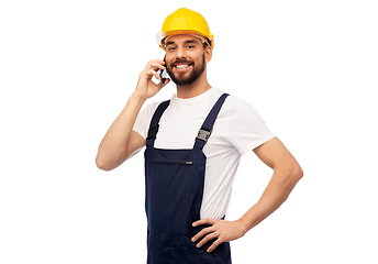 Image showing happy male worker or builder calling on smartphone