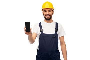 Image showing happy male worker or builder showing smartphone