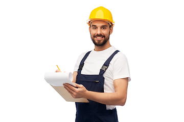 Image showing male worker or builder in helmet with clipboard