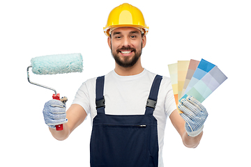 Image showing male builder with paint roller and color palettes