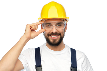 Image showing happy male worker or builder in helmet and overall