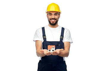 Image showing happy male builder holding model of living house