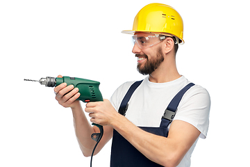 Image showing happy male worker or builder in helmet with drill